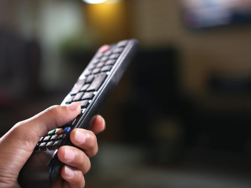 Person Holding Black Remote Control