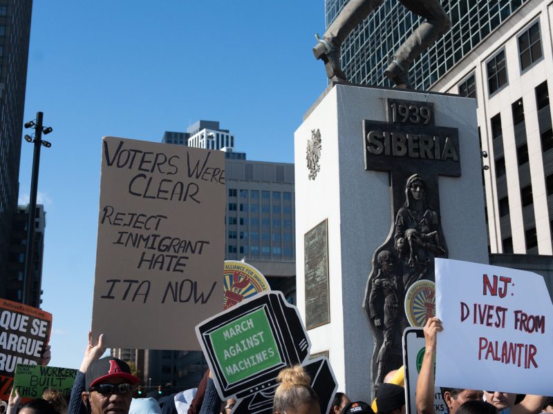 People hold signs that say voters were clear reject immigrant hate ITA now and NJ divest from palantir