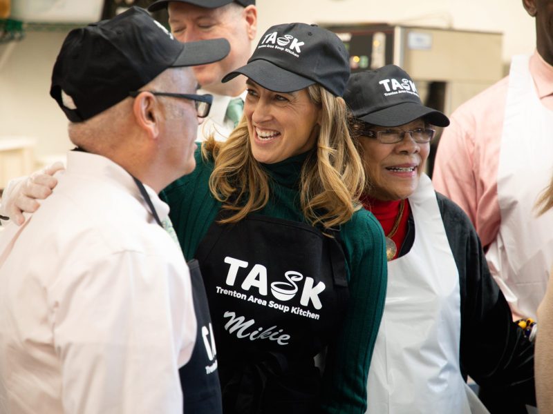 Mikie Sherrill smiles while putting arm around Red Gusciora's shoulder. Shirley Turner smiles next to her.