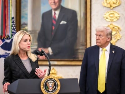 Pam Bondi on the left and Donald Trump on the right in the Oval Office - a portrait of Ronald Regan hangs behind them