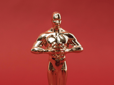 A replica of an Oscar award on a red background