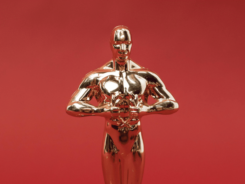 A replica of an Oscar award on a red background