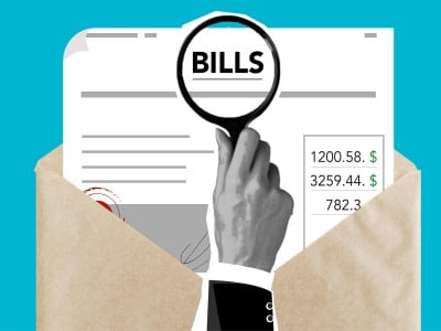 Open envelope with paper. Hand holds magnifying glass over the word "bills."